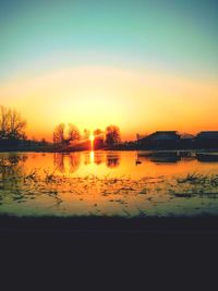 Scenic view of lake against romantic sky at sunset