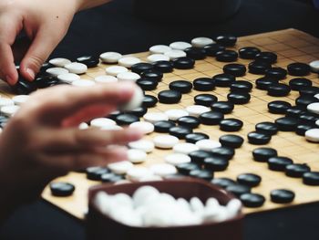 Cropped hand of people playing indoor game