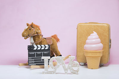 Various objects against pink wall