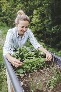 Woman holding food on plant