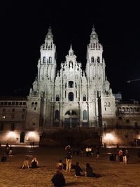 Group of people in front of building at night