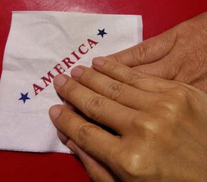 Close-up of person holding paper with text