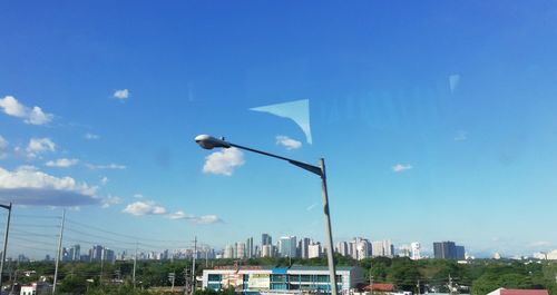 Low angle view of street against blue sky