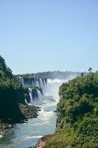 Scenic view of waterfall against sky