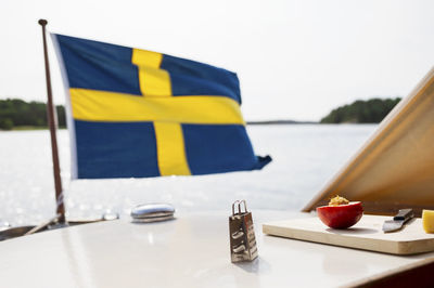 Food on boat, swedish flag in background, sweden