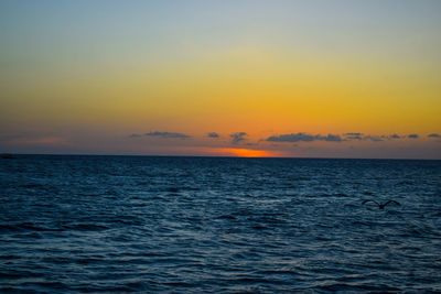 Scenic view of sea against romantic sky at sunset