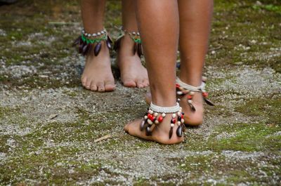 Low section of children with ankles dancing on field