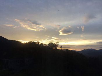 Scenic view of silhouette mountains against sky at sunset