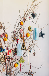 High angle view of decorations and face masks hanging on tree