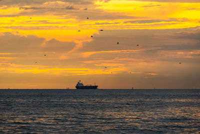 Scenic view of sea against orange sky