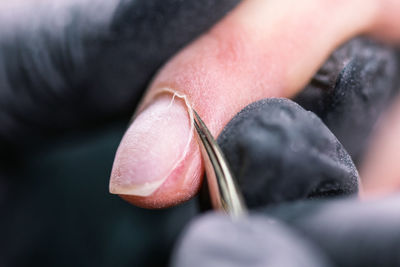 Close-up of woman hand holding black background