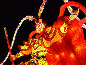 Low angle view of illuminated statue at night