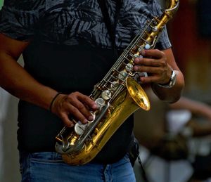 Midsection of man playing guitar