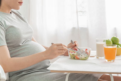Midsection of woman having food