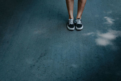 Low section of woman standing on floor