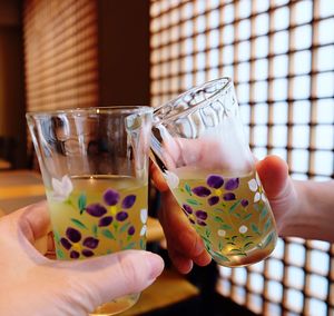 Cheers with tea cups with beautiful patterns