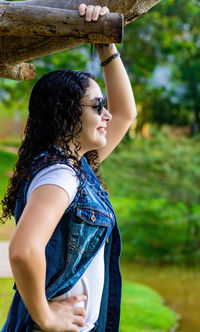 Side view of a young woman standing outdoors