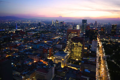 High angle view of illuminated city buildings at night