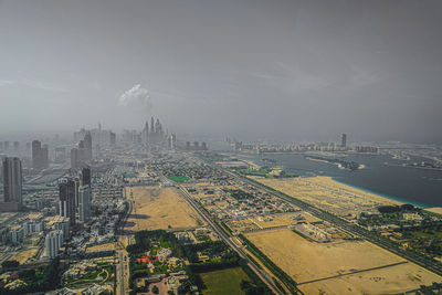 High angle view of city buildings against sky