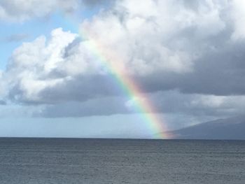 Rainbow over sea against sky