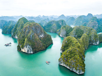 High angle view of rocks in sea against sky