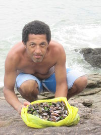 Portrait of man wearing sunglasses at beach