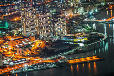 High angle view of illuminated buildings in city at night