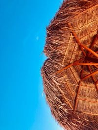 Low angle view of palm tree against clear blue sky