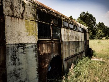 Abandoned built structure on land against sky