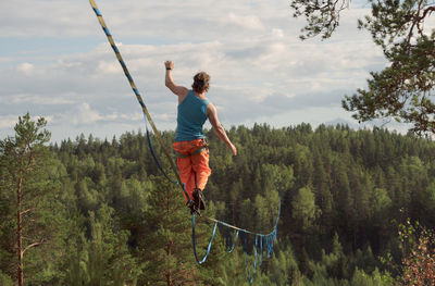 Long highline over the forest. tightrope walker