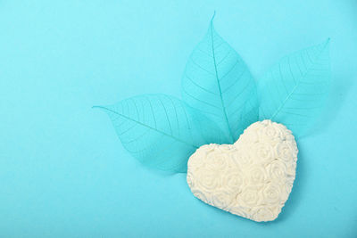 Close-up heart shaped decoration against blue background