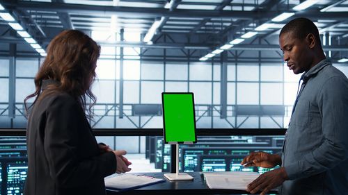 Side view of woman using laptop at office