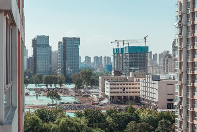 Trees and buildings against sky