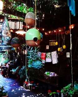 Illuminated lanterns hanging at market stall