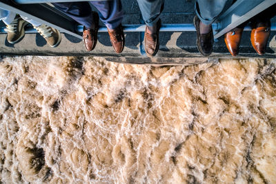 Low section of men standing on dam