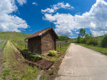 Road amidst field against sky