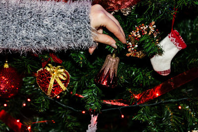 Cropped of hand holding christmas decoration 
