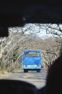 Vintage car on road seen through windshield