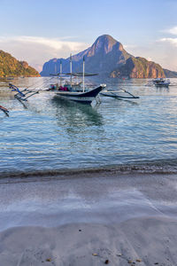 Boats moored on sea against sky