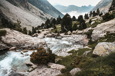 Scenic view of river amidst mountains against sky