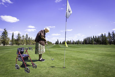 Full length of woman playing golf