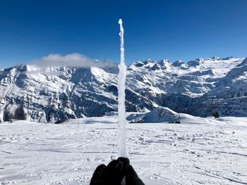 Snow covered mountains against blue sky