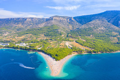 Aerial view of sea and mountains against sky