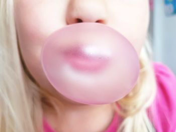 Close-up of girl blowing bubble gum