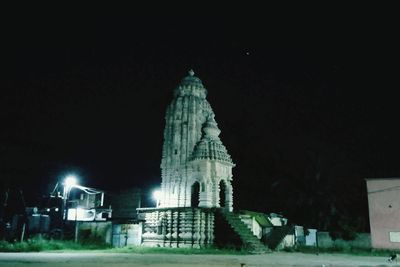 Illuminated building against sky at night