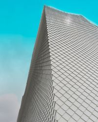 Low angle view of modern building against blue sky