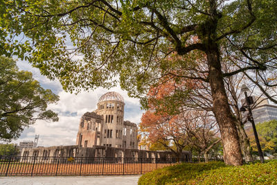 View of trees and building against sky