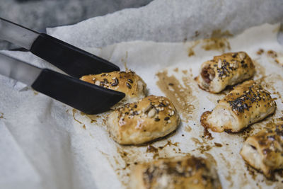 Anonymous person taking bun from parchment