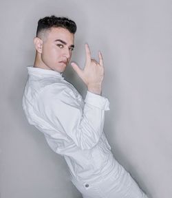 Portrait of young man against white background