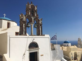 Built structure in city against blue sky